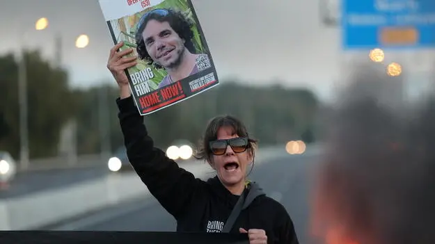 epa11207122 A demonstrator holds up a placard as families and supporters of Israeli hostages held by Hamas in Gaza block the main road leading from Tel Aviv to Jerusalem, during a protest demanding their release, near Ben Gurion airport, Israel, 08 March 2024. According to the Israeli military, over 100 Israelis, who were abducted and taken to the Gaza Strip during the 07 October 2023 attacks by Hamas, remain in captivity. Rallies in Israel have been critical of the government, demanding more action to free the hostages. EPA/ABIR SULTAN