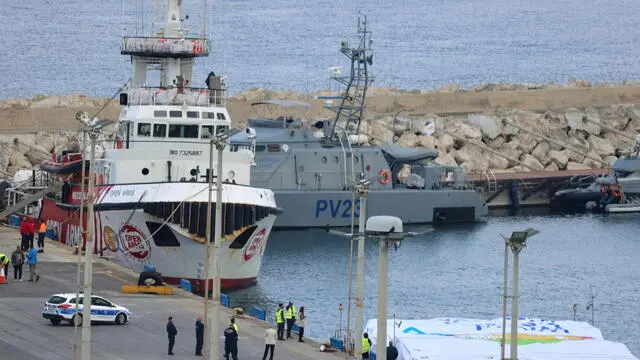 epaselect epa11211335 A view shows the boat of NGOs Open Arms and World Central Kitchen (WCK), which is scheduled to depart towrad Gaza, with UAE aid loaded on a barge (R), docked at Larnaca harbour, Cyprus, 10 March 2024. According to NGO Open Arms, the NGO together with WCK, another NGO involved with aid inside Gaza, it is working in a joint mission to establish a humanitarian matritime corridor from Larnaca to Gaza. WCK said that the first aid shipment is a UAE aid one, it is due to depart from Larnaca on 11 March. EU President Ursula von der Leyen announced on 08 march during a visit to Cyprus that she expected a maritime aid corridor to start operating between Cyprus and Gaza this weekend, "taking desperately-needed aid to besieged Palestinians'. EPA/KATIA KRISTODOULOU