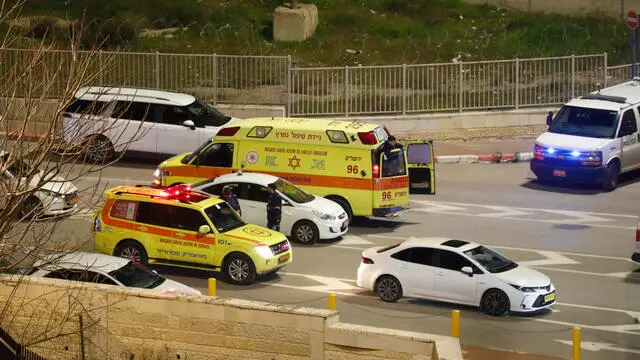 epa10465408 Israeli security and medicals at the scene of a stabbing attack at military checkpoint at the entrance Shuafat refugee camp in east Jerusalem, on 13 February 2023. Israeli police report that in response to the stabbing attack, the civilian security guard fired at the alleged attacker 13-year-old resident of Shuafat refugee camp, in order to neutralize him, the shot hit the officer as well and get seriously wounded. A Large forces of the Jerusalem District and the border police arrived at the scene and closed the checkpoint to traffic. EPA/ATEF SAFADI
