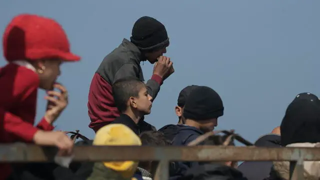 epa11181346 Palestinians travel on the back of a truck along Al Rashid road after crossing from the northern Gaza Strip into the south of Gaza city, 25 February 2024. Since 07 October 2023, up to 1.9 million people, or more than 85 percent of the population, have been displaced throughout the Gaza Strip, some more than once, according to the United Nations Relief and Works Agency for Palestine Refugees in the Near East (UNRWA), which added that most civilians in Gaza are in 'desperate need of humanitarian assistance and protection'. EPA/MOHAMMED SABER