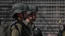 epa11151587 Israeli soldiers on guard at the gate of the Nitzana border crossing between Israel and Egypt, in southern Israel, as protesters attempt to prevent humanitarian aid from reaching the Gaza Strip, 14 February 2024. More than 28,300 Palestinians and over 1,300 Israelis have been killed, according to the Palestinian Health Ministry and the Israel Defense Forces (IDF), since Hamas militants launched an attack against Israel from the Gaza Strip on 07 October 2023, and the Israeli operations in Gaza and the West Bank which followed it. EPA/ATEF SAFADI