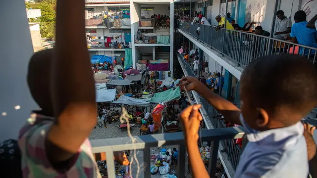 epa11221479 People gather inside a school where they are refugees in Puerto Principe, Haiti, 14 March 2024. More than a million children and adolescents are trapped by the violence of armed gangs in Haiti, living in areas controlled or under the influence of these groups, which represents a quarter of the country's child population, according to the humanitarian organization Save the Children. EPA/JOHNSON SABIN