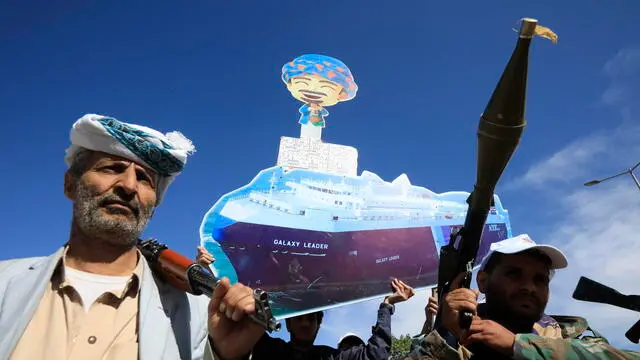 epa11134356 New Houthi recruits hold a sign depicting the cargo vessel Galaxy Leader, seized by the Houthis in the Red Sea in late 2023, during a parade against the United States and Israel, in Sana'a, Yemen, 07 February 2024. Yemen's Houthis held a parade for new recruits of the people's army nearby the now-closed embassies of the United Kingdom and Qatar in Sana'a, as part of a mobilization campaign for a possible confrontation with the United States and Israel amid fears of a wider regional conflict stemming from the Houthi escalation of attacks on shipping lanes in the Red Sea and the Gulf of Aden. The United States Central Command said it had identified six anti-ship ballistic missile launches by Houthis from areas of Yemen toward the southern Red Sea and the Gulf of Aden. In January 2024, the US Department of State designated Yemen's Houthis as a 'Specially Designated Global Terrorist group' due to their increased attacks on shipping lanes. In December 2023, the US Department of Defense announced a multinational operation to safeguard trade and protect ships in the Red Sea in response to the escalation of Houthi attacks. EPA/YAHYA ARHAB