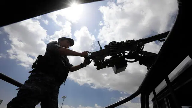 epa11212138 A Houthi soldier mans a machine gun on a vehicle while on patrol in Sana'a, Yemen, 10 March 2024. Yemen's Houthis will continue launching more missile and drone attacks at shipping lanes in the Red Sea and the Gulf of Aden during the Muslim fasting month of Ramadan as part of efforts to pressure Israel to put an end to the bombardment of the Gaza Strip, according to a speech by top Houthi leader, Abdul-Malik al-Houthi. The US-led coalition continues to strike Houthi targets in Yemen as it seeks to degrade the Houthis' abilities to attack commercial shipping vessels amid high tensions in the Middle East. EPA/YAHYA ARHAB