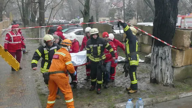 epa11222674 Ukrainian rescuers carry the body of their dead colleague near the site of a Russian rocket attack in the southern city of Odesa, Ukraine, 15 March 2024. After rescuers arrived at the scene of the attack on a civilian ifrastructure object, the location was struck by a second rocket, killing at least one rescuer. At least 16 people died and 53 others were injured following a Russian double rocket attack on a civilian infrastructure object and private buildings around it, in Odesa, according to Ukraine's State Emergency Service report. Russian troops entered Ukrainian territory in February 2022, starting a conflict that has provoked destruction and a humanitarian crisis. EPA/IGOR TKACHENKO