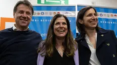 Giuseppe Conte con Alessandra Todde e Elly Sclhein ial quartier generale della Todde Cagliari 27 Febbraio 2024 ANSA\Fabio Murru