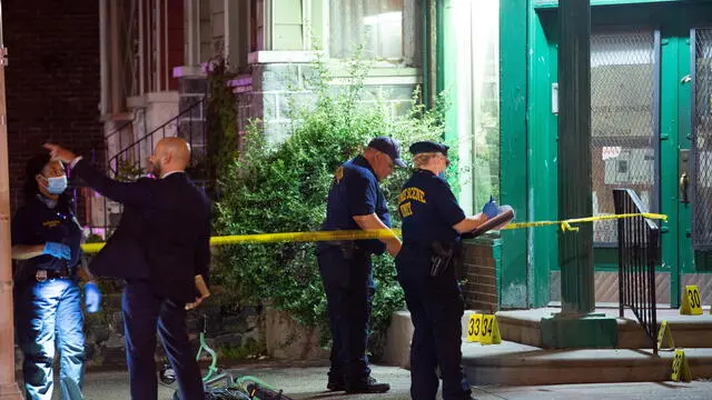 epa10725052 Police officials work at the scene of a mass shooting in the Kingsessing section of South Philadelphia, Pennsylvania, USA, 03 July 2023. Four people were killed and two others injured by a suspect who police placed into custody after capturing him wearing a bulletproof vest and carrying multiple weapons, according to the Philadelphia Police Department. EPA/TRACIE VAN AUKEN