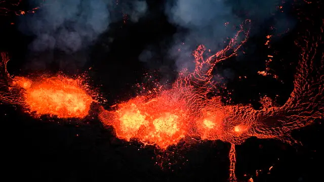 epa11037725 An aerial view taken with a drone shows lava and smoke spewing from a volcanic fissure during an eruption, near the town of Grindavik, in the Reykjanes peninsula, southwestern Iceland, 19 December 2023. The Icelandic Meteorological Office (IMO) announced the start of a volcanic fissure eruption near the Sundhnuka crater, north-east of Grindavik, on the night of 18 December, following weeks of intense earthquake activity in the area. The power and seismic activity of the eruption have decreased over time, IMO reported on 19 December, adding that since the eruption began, about 320 earthquakes have been recorded. EPA/ANTON BRINK