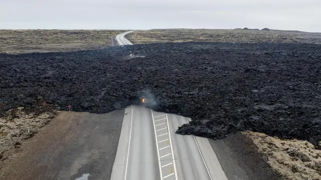 epa11226788 A view of a lava field covering a road following a volcano eruption, near Hagafell in the Reykjanes Peninsula, Southwestern Iceland, 17 March 2024. According to Icelandic authorities, a state of emergency was declared on 17 March after a volcanic eruption between stora Skogfell and Hagafell in the Reykjanes Peninsula of Iceland. EPA/Anton Brink