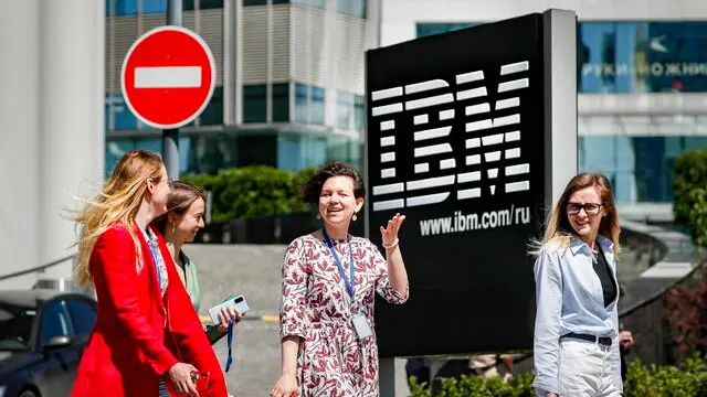 epa10002127 People walk past the logo of US corporation IBM in front of its office in Moscow, Russia, 08 June 2022. US corporation IBM posted on the company's website a statement announcing the company's decision to wind down of IBM's business in Russia. Three months earlier, on 07 March 2022, IBM announced the suspension of its business operations in Russia after Russian troops entered Ukraine on 24 February 2022. EPA/YURI KOCHETKOV