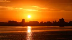 epa11227915 View of sunrise from the pier in Havana, Cuba, 18 March 2024. EPA/ERNESTO MASTRASCUSA