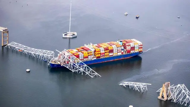 BALTIMORE, MARYLAND - MARCH 26: In an aerial view, cargo ship Dali is seen after running into and collapsing the Francis Scott Key Bridge on March 26, 2024 in Baltimore, Maryland. Rescuers are searching for at least seven people, authorities say, while two others have been pulled from the Patapsco River. Tasos Katopodis/Getty Images/AFP (Photo by TASOS KATOPODIS / GETTY IMAGES NORTH AMERICA / Getty Images via AFP)