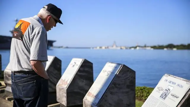epa05663419 A handout picture made available by the US Department of Defense (DOD) shows former US Sailor Mark Berrett reading the plaques of the Waterfront Memorial during the Freedom Bell Opening Ceremony and Bell Ringing at USS Bowfin Submarine Museum & Park on Pearl Harbor, near Honolulu, Hawaii, USA, 06 December 2016. Civilians, veterans, and service members came together to remember and pay their respects to those who fought and lost their lives during the attack on Pearl Harbor. Upcoming 07 December 2016 marks the National Pearl Harbor Remembrance Day and the 75th anniversary of the attack on Pearl Harbor by the Imperial Japanese Navy. EPA/LANCE CPL. ROBERT SWEET/US MARINE CORPS FORCES / HANDOUT HANDOUT EDITORIAL USE ONLY