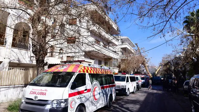 epa11091718 Ambulances are seen at the site of residential building that was targeted in an alleged Israeli strike in Mezzah neighborhood, Damascus, Syria, 20 January 2024. According to Syrian state-run media, at least five people were killed in an Israeli attack targeting a residential building in Mezzah neighborhood in Damascus on 20 January. The Israeli army did not comment on the event. EPA/STR