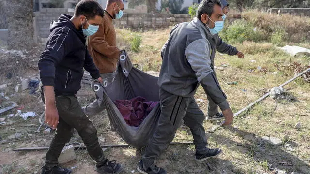 epa11254386 Palestinians carry items as they inspect the damage at Al-Shifa Hospital after the Israeli army withdrew from the hospital following a two-week military operation, in Gaza City, 01 April 2024. An Israeli army spokesperson reported that Israeli forces completed operations at Al-Shifa hospital with about 500 affiliated suspects arrested and 200 eliminated. More than 32,700 Palestinians and over 1,450 Israelis have been killed, according to the Palestinian Health Ministry and the Israel Defense Forces (IDF), since Hamas militants launched an attack against Israel from the Gaza Strip on 07 October 2023, and the Israeli operations in Gaza and the West Bank which followed it. EPA/MOHAMED HAJJAR