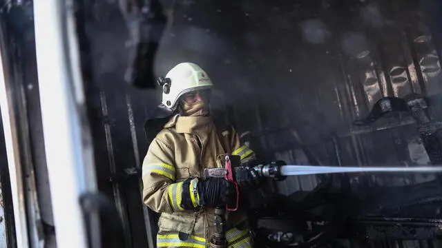 epa09509422 Female firefighter Dilara Karabulut works on a site of a fire incident in Sisli district, Istanbul, Turkey, 04 October 2021. (Issued 06 October 2021). The historic 100-year-old firefighting department in Istanbul, since the summer, has welcomed women in Turkey, a majority Muslim country ruled by the Islamic conservative AKP, to its ranks. “When I grow up I want to be a firefighter†was not something any of these 37 women ever said when they were girls. Even though there have been female firefighters in some towns since 1988, seeing a woman wielding an axe and hose in Turkey is still extremely rare. "It's not considered a woman's job, but since I was little I used to do things that are seen as boys' jobs, so my family didn't see anything unusual about it," says Ceyda Cirik, 22, at the fire station in Basaksehir, a suburb of Istanbul. She has just returned from an operation in a burned-out factory, along with her colleagues Esra Ücler and Rüveyda Tös. The three of them are part of a team with about 10 men who, after initially viewing the new recruits with suspicion, soon got used to the novelty. Being a firefighter has a long tradition in Istanbul, which was formerly built almost entirely of wood. The volunteer fire departments, the so-called 'tulumbacilar' of the 18th and 19th centuries, with their iconic uniform of jacket, stilts and sash, became an image of masculinity and courage. The offer of 50 vacancies for female firefighters - 37 of which only could be filled, as not all candidates passed the exams and physical tests - is quite the political statement from the Istanbul mayor's office, which since 2019 has been in the hands of the social democratic CHP party, the AKP's main rival. EPA/SEDAT SUNA