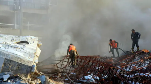 epa11254837 Rescue workers at the site of an airstrike in Damascus, Syria, 01 April 2024. According to the Syrian Arab News Agency SANA, Israel on 01 April launched an airstrike targeting the Iranian consulate building in Damascus. The consulate was damaged while the building next to it was destroyed. EPA/YOUSSEF DAFAWWI