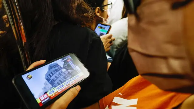 epa11256371 A passenger on a subway train watches a TV news report about a residential building collapsed in Hualien following a magnitude 7.4 earthquake, in Taipei, Taiwan, 03 April 2024. A magnitude 7.4 earthquake struck Taiwan on the morning of 03 April with an epicentre 18 kilometres south of Hualien City at a depth of 34.8 km, according to the United States Geological Survey (USGS). EPA/DANIEL CENG