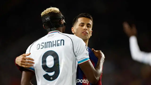 epa11217388 FC Barcelona's Joao Cancelo (R) embraces Victor Osimhen of Napoli during the UEFA Champions League round of 16 second leg soccer match between FC Barcelona and SSC Napoli, in Barcelona, Catalonia, Spain, 12 March 2024. EPA/Alberto Estevez