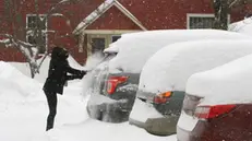 epa07304242 A woman brushes snow from her car in Wilder, Vermont, USA 20 January 2019. The region of central Vermont has received over 16 inches of snow so far. Temperatures were predicted to drop well below freezing overnight with officials warning of a 'flash freeze' of all coated surfaces EPA/HERB SWANSON