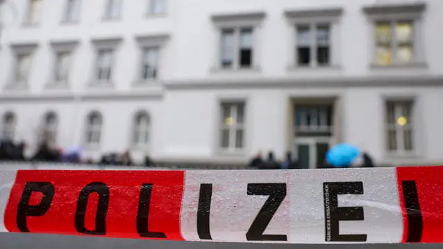 epa11037075 A police cordon as demonstrators protest against police violence in front of the district court prior to the start of a trial against five police officers at the district court in Dortmund, Germany, 19 December 2023. Eleven trial days have been scheduled so far until April 2024 on which the court must clarify why the police operation escalated and 16-year-old Mouhamed Drame was killed by shots from a police machine gun in August 2022. EPA/CHRISTOPHER NEUNDORF