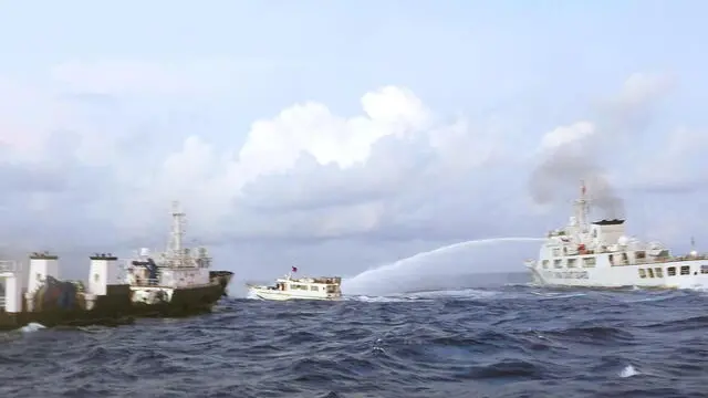 epa11022318 A handout photo made available by the Philippine Coast Guard (PCG) shows a Chinese Coast Guard ship (R) firing water cannon on Philippine Navy operated supply boat (M/L Kalayaan) (C) in the disputed South China Sea, Philippines, 10 December 2023 (issued on 11 December 2023). According to a report from the Philippine Coast Guard (PCG), on 10 December, Chinese coastguard ships fired water cannons and rammed one of the Philippine resupply vessels that suffered serious engine damage during a resupply mission in the disputed South China sea. EPA/Philippine Coast Guard / HANDOUT BEST QUALITY AVAILABLE HANDOUT EDITORIAL USE ONLY/NO SALES HANDOUT EDITORIAL USE ONLY/NO SALES