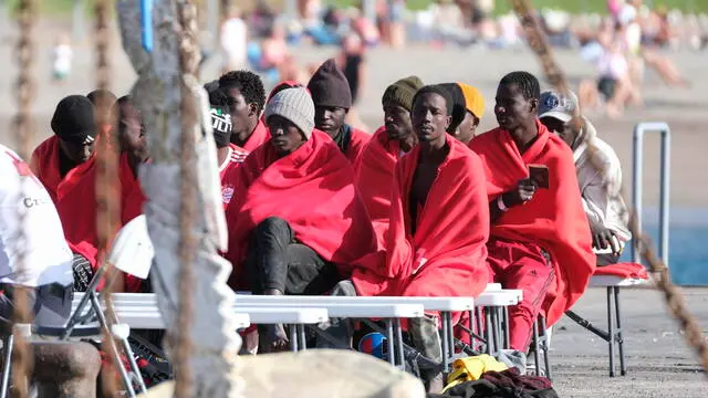 epa11120565 Several migrants rest after they were rescued at Los Cristianos port, in Tenerife island, Canary Islands, southwestern Spain, 02 February 2024. A Spanish Sea Rescue's ship rescued a boat with 41 migrants on board off Tenerife island, after Spanish authorities were alerted by a commercial vessel. EPA/Alberto Valdes