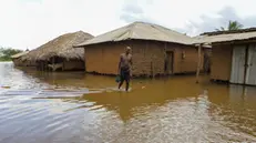 epa11015864 A man wades in flood waters in Shirikisho village, Tana Delta region, in Kenya, 07 December 2023. The death tool due to rainfalls and floods in Kenya has surged to 160 and displaced more than 500,000 people according to the government. Since November 2023, Kenya, Somalia and Ethiopia have been affected by downpours linked to the El Nino phenomenon. EPA/ANDREW KASUKU