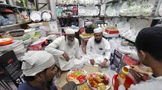 epa11255501 Muslims prepare to break their fast at a market during the holy fasting month of Ramadan, in Kolkata, India, 02 April 2024. The Muslims' holy month of Ramadan is the ninth month in the Islamic calendar and it is believed that the revelation of the first verse in the Koran was during its last 10 nights. It is celebrated yearly by praying during the night time and abstaining from eating, drinking, and sexual acts during the period between sunrise and sunset. It is also a time for socializing, mainly in the evening after breaking the fast and a shift of all activities to late in the day in most countries. EPA/PIYAL ADHIKARY