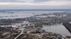 epa11267325 A handout photo taken from a video made available by the Russian Emergency Situations Ministry shows an aerial view of the flooded zone in Orsk, Orenburg region, Russia, 09 April 2024. A protective embankment dam, introduced in 2010, broke on 05 April in Orsk. According to the latest data, more than 2,000 people were evacuated and 16 temporary accommodation centers have been deployed in the city. Orsk Mayor Vasily Kozupitsa reported on his Telegram channel that the water level in the Urals dropped by 39 cm in one day. EPA/RUSSIAN EMERGENCIES MINISTRY HANDOUT - BEST QUALITY AVAILABLE - HANDOUT EDITORIAL USE ONLY/NO SALES HANDOUT EDITORIAL USE ONLY/NO SALES