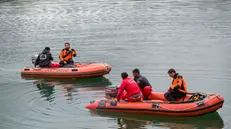 epa11269759 Rescuers on dinghies try to access the power plant on Lake Suviana during the search operations for those missing following an explosion, in Bargi, Italy, 10 April 2024. According to the Italian fire brigade (Corpo Nazionale dei Vigili del fuoco), at least three people died and four are missing after an explosion at the hydroelectric power plant in Bargi that took place on 09 April. EPA/MICHELE LAPINI