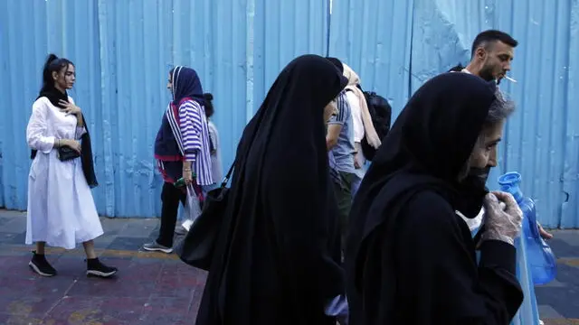 epa10858504 Iranian women, some without the mandatory headscarf, walk in a street in Tehran, Iran, 13 September 2023. Iranians are marking the first anniversary of Mahsa Amini's death which led to nationwide protests over the country's mandatory dress code (Hijab) law. Protests erupted after the death of 22-year old Iranian woman, Mahsa Amini, detained by morality police for not wearing the hijab properly in September 2022. Since then, a growing number of women in the country have been defying authorities by removing the headscarf. EPA/ABEDIN TAHERKENAREH