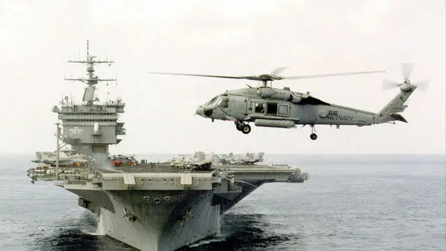 DCA99 - 19981110 - WASHINGTON, DC, UNITED STATES : (FILES) In this file photo A US Navy SH-60 helicopter hovers off the bow of the USS Enterprise 20 July 1988 during a training exercise near Puerto Rico. US Defense Secretary William Cohen has ordered to the Gulf the Enterprise and more amphibious assault ships to support the carrier USS Eisenhower and thirteen other ships. EPA PHOTO AFP FILES-US NAVY/TIMOTHY SMITH