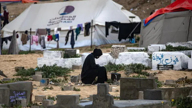 epa11269330 A displaced Palestinian, who escaped the ongoing conflict between Israel and Hamas, visits a loved one tomb on the first day of Eid al-Fitr at the Rafah camp in the southern Gaza Strip, 10 April 2024. Muslims worldwide celebrate Eid al-Fitr, a two or three-day festival at the end of the Muslim holy fasting month of Ramadan.It is one of the two major holidays in Islam. During Eid al-Fitr, Most People travel to visit each other in town or outside of it and children receive new clothes and money to spend for the occasion.More than 33,100 Palestinians and over 1,450 Israelis have been killed, according to the Palestinian Health Ministry and the Israel Defense Forces (IDF), since Hamas militants launched an attack against Israel from the Gaza Strip on 07 October 2023, and the Israeli operations in Gaza and the West Bank which followed it. EPA/HAITHAM IMAD