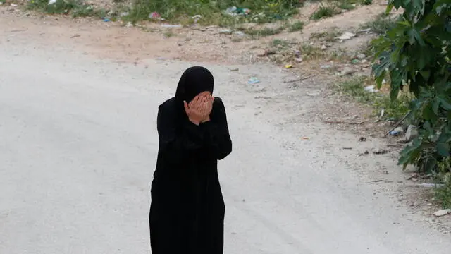 epa11276813 A relative of Palestinian Jihad Abu Alia mourns duing his funeral procession following clashes the previous night in the West Bank village of Al-Mughayyir, near Ramallah, 13 April 2024. According to the Palestinian Health Ministry, at least one Palestinian was killed and 27 others were wounded, while dozens of vehicles and houses were set ablaze by settlers during clashes that erupted the previous night amid an Israeli operation in the area. Settlers rampaged through several Palestinian West Bank villages on 11 and 12 April, vandalizing property and causing injuries and a fatality during the search for missing Israeli teen Benjamin Achimeir. The teenager's body was found nearby, Israeli authorities said on 13 April. EPA/ALAA BADARNEH