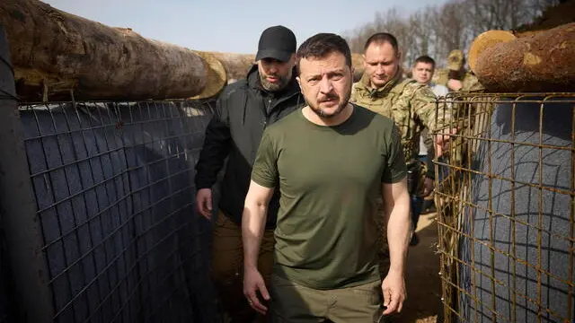 epa11267436 A handout photo made available by the Presidential Press Service shows Ukrainian President Volodymyr Zelensky (C) and the head of the Kharkiv Regional Military Administration Oleh Syniehubov (L background) visit the construction site of a defence line in the Kharkiv region, Ukraine, 09 April 2024 amid the Russian invasion. Russian troops entered Ukrainian territory on 24 February 2022, starting a conflict that has provoked destruction and a humanitarian crisis. EPA/PRESIDENTIAL PRESS SERVICE HANDOUT HANDOUT HANDOUT EDITORIAL USE ONLY/NO SALES HANDOUT EDITORIAL USE ONLY/NO SALES