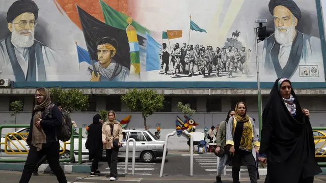 epa11281919 Iranians walk past a mural of Iranian supreme leader Ayatollah Ali Khamenei (top-L) and late Iranian supreme leader Ayatollah Ruhollah Khomeini (top-R) in Tehran, Iran, 16 April 2024. Iranian President Ebrahim Raisi on 14 April said any new targeting of his country will be met with stronger response, after Iran's Islamic Revolutionary Guards Corps (IRGC) launched drones and rockets towards Israel late on 13 April. The Israeli Chief of the General Staff LTG Herzi Halevi said on 15 April the Iranian launch of missiles and drones against Israel will be met with a response. EPA/ABEDIN TAHERKENAREH