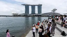 epa11154114 People take photos at Merlion Park with Marina Bay Sands in the background in Singapore, 15 February 2024. Singaporeâ€™s Ministry of Trade and Industry (MTI) announced on 15 February 2024 that the Singapore economy expanded by 1.1 percent in 2023. MTI has maintained the GDP growth forecast for 2024 at 1.0 to 3.0 percent. EPA/HOW HWEE YOUNG