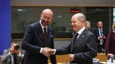 epa11285006 German Chancellor Olaf Scholz (R) and European Council President Charles Michel (L) shake hands at a roundtable during a special meeting of the European Council in Brussels, Belgium, 17 April 2024. EU leaders gather in Brussels for a two-day summit to discuss the economy and competitiveness, as well as Ukraine, Turkey and the Middle East, including Lebanon, among other issues. EPA/OLIVIER MATTHYS
