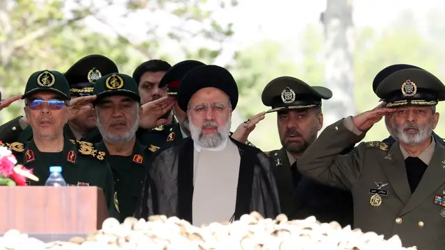 epa11283789 Iranian President Ebrahim Raisi (C), flanked by Iranian IRGC and Army generals, arrives during the annual Army Day celebration at a military base in Tehran, Iran, 17 April 2024. According to Iranian state media, Raisi described the recent attack launched towards Israel as 'limited' and 'punitive', adding that any act of aggression against Iran will be dealt with a 'powerful and fierce' response. Iran's Islamic Revolutionary Guards Corps (IRGC) launched drones and rockets towards Israel late on 13 April. EPA/ABEDIN TAHERKENAREH
