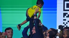 epa11247634 The former president of Brazil, Jair Bolsonaro (2019-2022), lifts a child during the incorporation ceremony of Senator Izalci Lucas to the Liberal Party (PL) in Brasilia, Brazil, 27 March 2024. EPA/Andre Borges