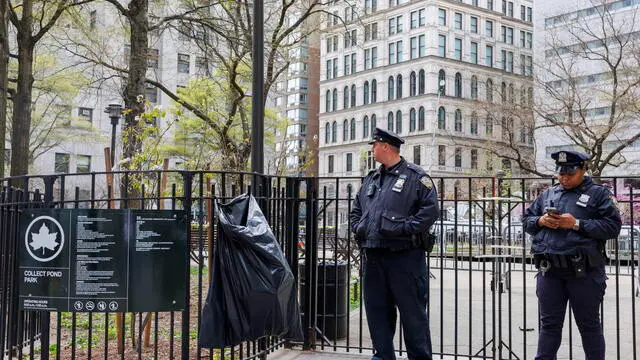 epa11289319 Police officers guard an entrance to the park at the scene where a man set himself on fire at Collect Pond Park, outside Manhattan Criminal Court, where former president Donald Trump is attending jury selection for his criminal trial, in New York, USA, 19 April 2024. The New York City Police Department confirmed on 19 April that a man walked to the center of the park directly opposite the New York County Criminal Court and threw some pamphlets in the air before setting himself on fire. The individual was then moved to a hospital where he was admitted in critical conditions. EPA/SARAH YENESEL