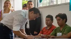 epa11292057 Ecuadorian President Daniel Noboa (L) votes in a referendum proposed by his government in Olon, Ecuador, 21 April 2024. Ecuadorians are called to vote on a referendum to decide on issues including security, justice, investments, and employment on 21 April. EPA/Mauricio Torres