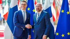 epa11269680 Finland's President Alexander Stubb (L) is welcomed by the European Council President Charles Michel (R), ahead of a meeting in the European Council building in Brussels, Belgium, 10 April 2024. EPA/OLIVIER MATTHYS