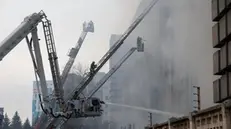 epa11231883 Ukrainian firefighters work to extinguish a fire at the site of a rocket attack on an industrial building in the Kholodnohirskyi district of Kharkiv, northeastern Ukraine, 20 March 2024, amid the Russian invasion. At least five people were killed and at least 6 others were injured after a Russian missile strike hit one of the districts of Kharkiv, the State Emergency Service of Ukraine said. The regional military administration reported that a number of people could be trapped under the rubble. EPA/SERGEY KOZLOV