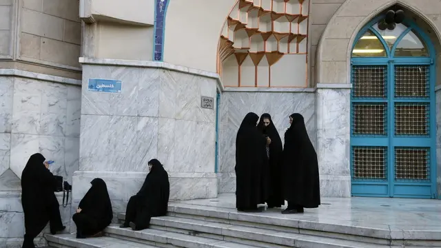 epa11280626 Veiled Iranian women wait in front of a mosque during a celebration following Iran's attack on Israel, at the Palestine square, in Teheran, Iran, 15 April 2024. Iran's Islamic Revolutionary Guards Corps (IRGC) launched drones and rockets towards Israel late on 13 April 2024, Iranian officials said. EPA/ABEDIN TAHERKENAREH