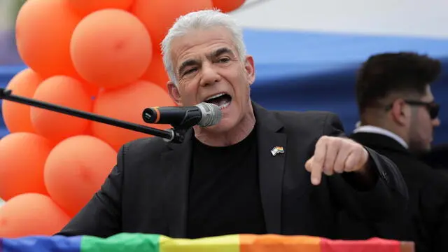 epa10667000 Israel opposition leader and former prime minister Yair Lapid speaks during the annual Gay Pride parade in Jerusalem, 01 June 2023. Thousands of members and supporters of the LGBTQ (lesbian, gay, bisexual, transgender, intersex, queer) community marched in the Jerusalem parade under tight police security. EPA/ABIR SULTAN