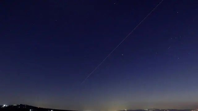 epa11285474 A long exposure photo shows an Israeli missile launched toward targets in Lebanon, as seen from northern Israel near the border with Lebanon, 17 April 2024. According to the Israeli army spokesperson, on 17 April evening IAF fighter jets struck Hezbollah infrastructure used by the organization's aerial defense system in northern Baalbek. EPA/ATEF SAFADI