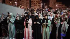 epa11261449 Muslim women perform night prayer on Laylat al-Qadr (Arabic for Night of Destiny) outside Amr Bin El-Aas Mosque in Cairo, Egypt, 05 April 2024. Laylat al-Qadr is believed to be the night when the first verse of Islam's holy book, the Koran, was revealed to Prophet Muhammad, the exact date is not known but it is believed to be on an odd night of the last 10 nights of the holy month of Ramadan. The Muslims' holy month of Ramadan is the ninth month in the Islamic calendar and it is believed that the revelation of the first verse in the Koran was during its last 10 nights. It is celebrated yearly by praying during the night time and abstaining from eating, drinking, and sexual acts during the period between sunrise and sunset. It is also a time for socializing, mainly in the evening after breaking the fast and a shift of all activities to late in the day in most countries. EPA/KHALED ELFIQI