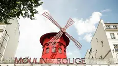 epa09928360 The mill that presides over the landmark 'Moulin Rouge' cabaret, in Paris, France, 04 May 2022 (issued 05 May 2022). For the first time in its 133-year history, the iconic Parisian cabaret 'Moulin Rouge' will open the doors of the famous mill that presides over the building to the public to turn it into a tourist accommodation, with the possibility of spending a night inside for one euro. EPA/Mohammed Badra
